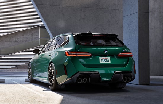 Green BMW M5 Touring parked in garage. | Open Road BMW of Edison in Edison NJ