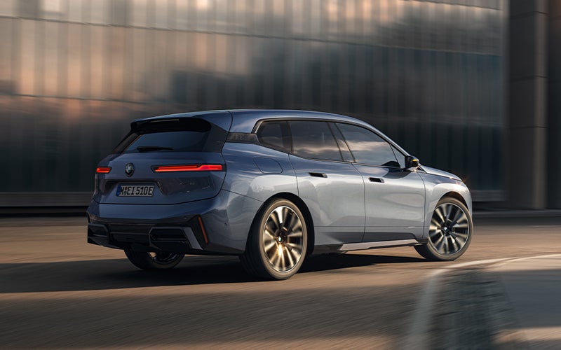 The BMW iX driving with the front wheel turned. | Open Road BMW of Edison in Edison NJ